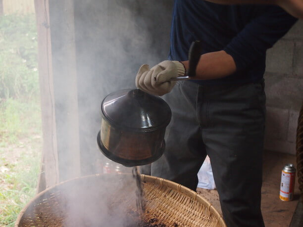 ざるの中へ移される熱々のコーヒー豆